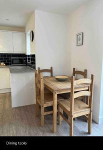 a dining table and chairs in a kitchen at Green 3 bed bungalow with en-suite and parking in Felton