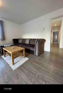 a living room with a couch and a coffee table at Green 3 bed bungalow with en-suite and parking in Felton