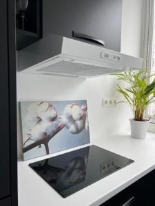 a white refrigerator with pictures of birds on it at Beautiful new apartment Antwerpen in Antwerp