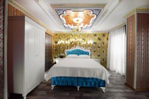 a bedroom with a large bed with a blue headboard at Babel Park Hotel in Istanbul