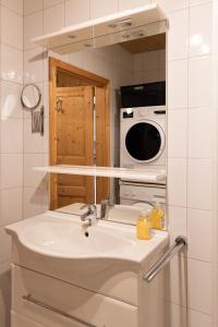 a kitchen with a sink and a microwave at My Chalet In Murau in Sankt Georgen ob Murau