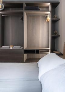 a bedroom with a white bed and two other beds at Guvi’sHome Bormio in Bormio