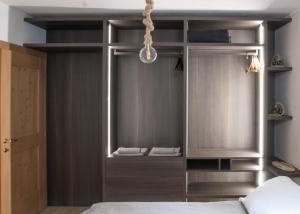 a room with a bed and a closet with a window at Guvi’sHome Bormio in Bormio