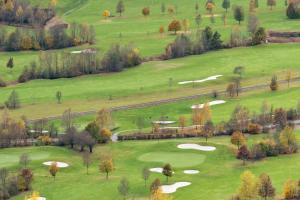 an aerial view of a golf course with green hills at My Chalet In Murau in Sankt Georgen ob Murau