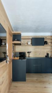 a kitchen with a blue island in a room at Guvi’sHome Bormio in Bormio