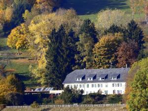 a large white house in the middle of a forest at Gîte Orbey, 2 pièces, 2 personnes - FR-1-744-25 in Orbey