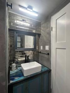 a bathroom with a sink and a mirror at Unique Style Apartment in Asbury Park