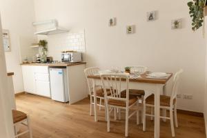 a kitchen with a table and chairs in a room at La Casa di Niky in Bracciano