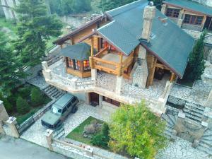 an overhead view of a house with a car in front at 7Hills Finnish Luxury Chalet by Ski Alure in Eptalofos