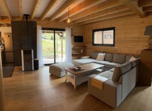 a living room with a couch and a table at Chalet La Morte in La Morte