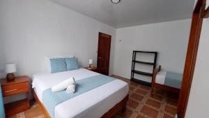 una camera con un letto con due cuscini sopra di Casa THIREMA Tortuguero a Tortuguero
