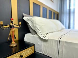 a bedroom with a bed and a statue on a table at Kos apartament 1 in Walton on the Hill