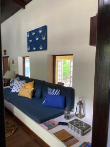 a blue couch sitting in a living room at Pousada Casa da Montanha in Angra dos Reis