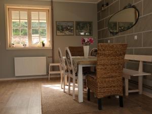 a dining room with a table and chairs at Villa Mira in Mačkat