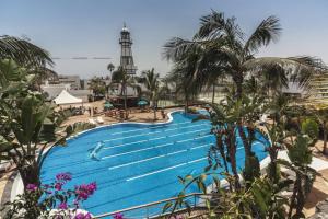 a pool at a resort with a lighthouse in the background at Luxury Suite Ocean Views in Tías