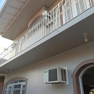 a balcony with a air conditioner on the side of a building at Hostel na Rota da Serra Gaúcha in Taquara +86 photos