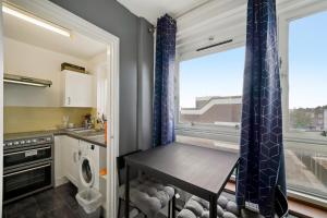 a small kitchen with a table and a window at Impeccable 1-Bed Apartment in London in London