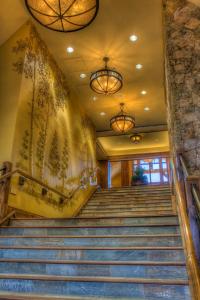 a set of stairs in a building with two chandeliers at Grand Lodge on Peak 7 in Breckenridge