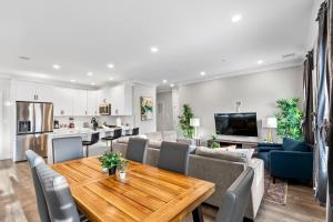 a kitchen and living room with a table and chairs at Spacious Fully Furnished Apartment by Logan Airport in Boston