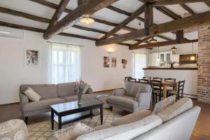 a living room with couches and a table and a kitchen at Villa Leopoldo by Istrian Country Houses in Barat