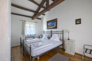 a bedroom with a large bed with white sheets at Villa Leopoldo by Istrian Country Houses in Barat +64 photos