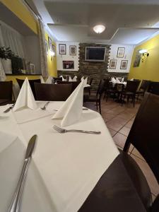 a table with white paper napkins on it in a restaurant at Gasthof Wildschönauer Bahnhof in Wörgl