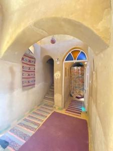 a hallway of a house with an archway and a door at Khan tunis villa in Tunis