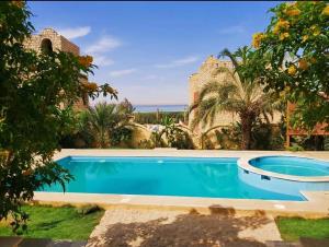 a swimming pool in front of a villa at Khan tunis villa in Tunis