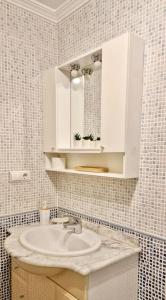 a bathroom with a white sink and a mirror at Flamingo Apart in Orihuela Costa +32 photos