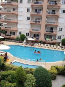 a large swimming pool in front of a building at Sokak in Alanya