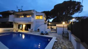 a house with a swimming pool in front of a house at La Casa d'Anna in Pals