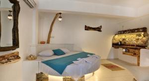 a bedroom with a bed with blue sheets and a fireplace at Limon Apart in Akyaka