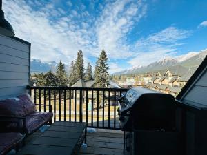 balkon z kanapą i widokiem na góry w obiekcie 2-in-1 Skyline MTN Retreat - Hot Tub - Pool - AC w mieście Canmore