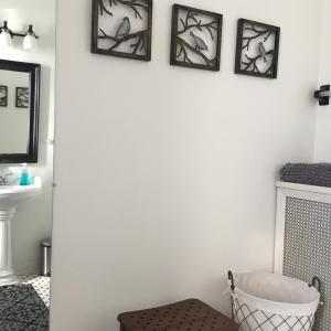 a bathroom with three framed pictures on the wall at Oak Park Beauties - Tree Lined Streets - Walkable in Oak Park