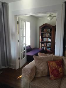 a living room with a couch and a book shelf at Oak Park Beauties - Tree Lined Streets - Walkable in Oak Park