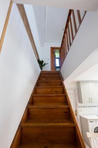 a staircase in a house with white walls and wooden floors at Elantxobe Centre in Elanchove