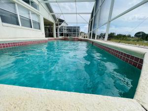 a swimming pool in front of a building at Home in davenport Cheerful 5-bedroom with private Pool close to Disney in Davenport
