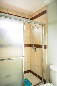a shower with a glass door in a bathroom at Relaxing Home With SF Bay View in Millbrae