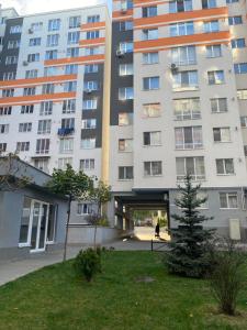 a large apartment building with a tunnel in front of it at MODERN MINIMALIST APARTMENT Close to Airport and City Center. in Chişinău