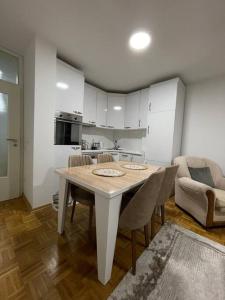 a kitchen with a table and chairs in a room at Apartment in Gjilan in Gnjilane