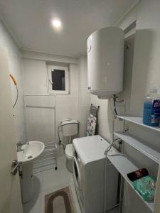 a small bathroom with a sink and a toilet at Apartment in Gjilan in Gnjilane