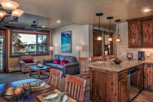 a kitchen and living room with a table and chairs at Grand Lodge on Peak 7 in Breckenridge