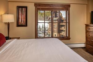 ein Schlafzimmer mit einem Bett und einem großen Fenster in der Unterkunft Grand Lodge on Peak 7 in Breckenridge