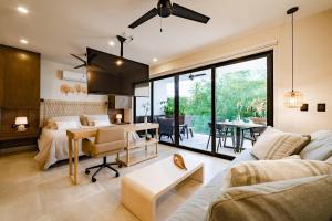a living room with a couch and a table at 3022 - Ziba Condo 203 in Santa Cruz Huatulco +21 photos