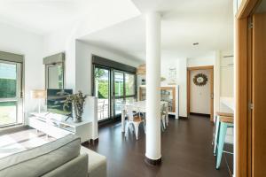 a living room with a couch and a table at helloasturias, Casa en Llanes con piscina, jardín, cerca de la playa. in Llanes