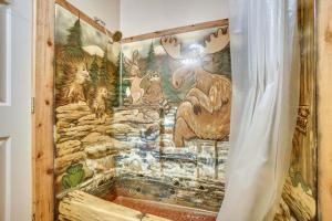 a mural of animals on a wall in a bathroom at Tree-Lined McCall Cabin Walk to Payette River! in McCall +27 photos