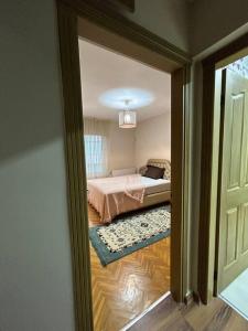 a view of a bedroom with a bed and a window at Harika ev aileler için in Konak