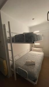 two bunk beds in a small room with at HOUSE TERRAZA PREMiUM 6PAX WIFI in Sierra Nevada