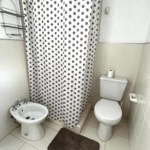 a bathroom with a toilet and a shower curtain at 248 Apartamento in Alta Gracia
