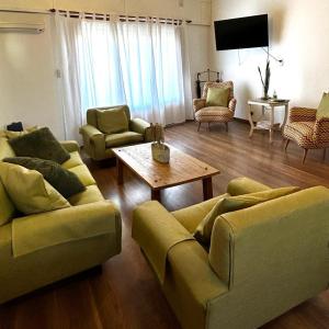 a living room with two couches and a table at 248 Apartamento in Alta Gracia
